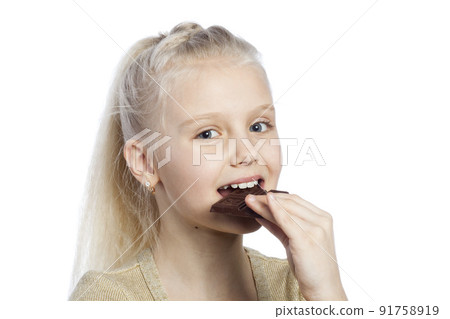 Beautiful girl eating chocolate. Beautiful girl eating chocolate. 91758919