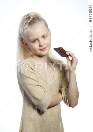 Beautiful girl eating chocolate. 91758923
