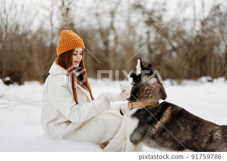 young woman in winter clothes in hats outdoors There is a lot of snow  around Stock Photo by shotprime