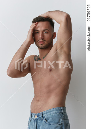 Sporty Sexy Muscular Handsome Naked Man holds hands on head posing isolated on over white studio background. Cool fashion offer. Model shoot for ad. Copy space 91759793