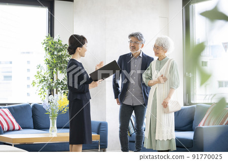 Senior couple and sales woman Senior couple and sales woman 91770025