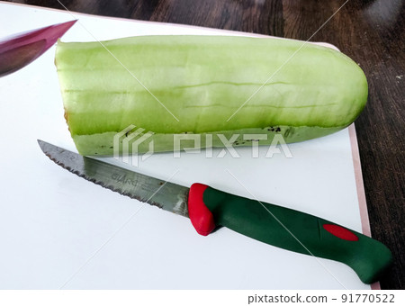 Sliced bottle gourd with Knife on the table Sliced bottle gourd with Knife on the table 91770522
