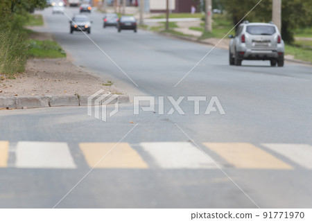 pedestrian crossing in street - white and yellow colors. side view pedestrian crossing in street - white and yellow colors. side view 91771970