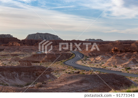Scenic Road surrounded by Red Rock Mountains in the Desert at Sunrise. Scenic Road surrounded by Red Rock Mountains in the Desert at Sunrise. 91773343