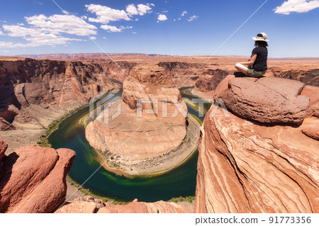 Adventurous Caucasian Woman at Horseshoe Bend in Page, Arizona, United States. Adventurous Caucasian Woman at Horseshoe Bend in Page, Arizona, United States. 91773356