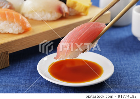 Tuna nigiri sushi lifted with chopsticks 91774182