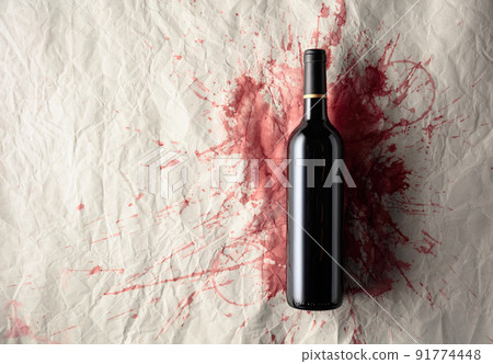 Bottle of red wine on a background with stains of wine. Bottle of red wine on a background with stains of wine. 91774448