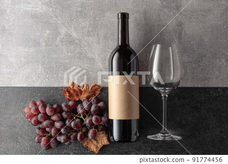 Red wine with grapes on a stone background. Red wine with grapes on a stone background. 91774456