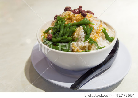 Close-up view of the cendol dessert with gula Melaka syrup. Cendol is made from crushed ice cubes, jelly, coconut milk, and red beans. Close-up view of the cendol dessert with gula Melaka syrup. Cendol is made from crushed ice cubes, jelly, coconut milk, and red beans. 91775694