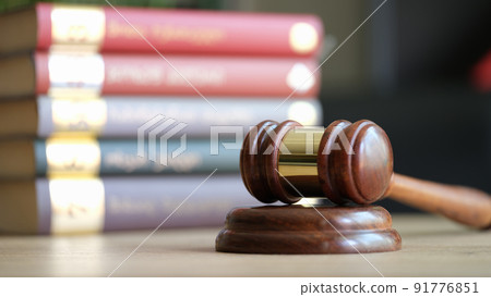 Judge gavel or hammer on sounding block and stack of law books Judge gavel or hammer on sounding block and stack of law books 91776851