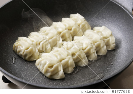 Dumplings baked in a frying pan Dumplings baked in a frying pan 91777658