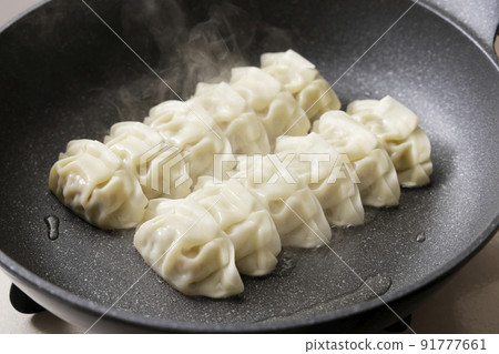 Dumplings baked in a frying pan Dumplings baked in a frying pan 91777661