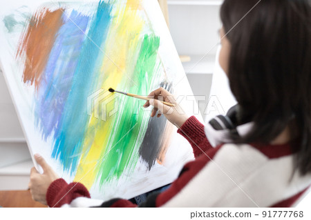 Female artist painting on canvas, Artist studio interior, Draw with watercolor, Drawing supplies , Painting and creativity, Use a brush to draw a pattern by stripes, Artwork, Using Paint Brush. Female artist painting on canvas, Artist studio interior, Draw with watercolor, Drawing supplies , Painting and creativity, Use a brush to draw a pattern by stripes, Artwork, Using Paint Brush. 91777768