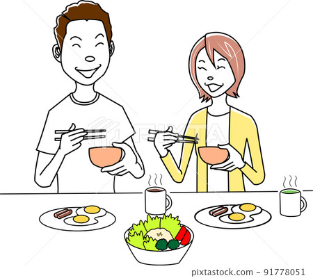 A couple talking while eating breakfast 91778051