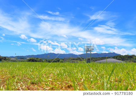 Grassland after mowing, blue sky, clouds, mountains Grassland after mowing, blue sky, clouds, mountains 91778180