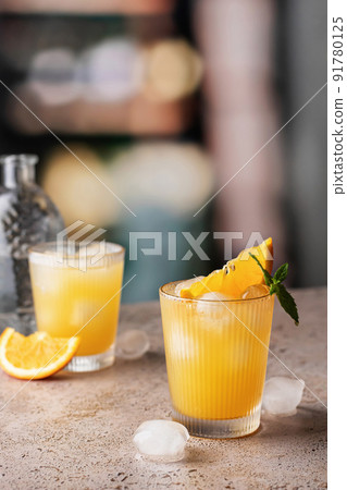 Orange and mint cocktails, soft drinks on bar with text space Orange and mint cocktails, soft drinks on bar with text space 91780125