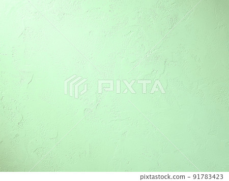 Horizontal background image where light green light hits the plastered wall with trowel marks 91783423