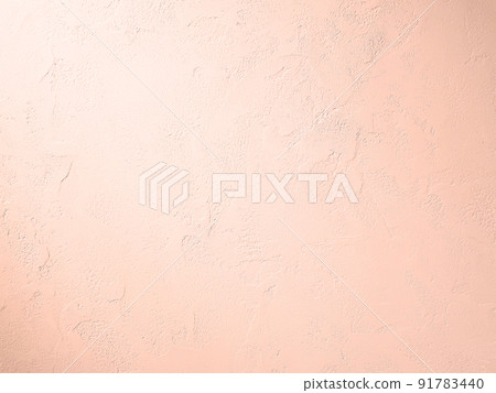 A horizontally long background image in which a light pink light hits a plastered wall with trowel marks. 91783440
