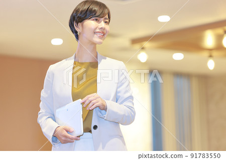 Business woman walking in the office with a tablet 5 Business woman walking in the office with a tablet 5 91783550