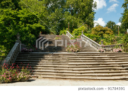 Big beautiful old stone stairs with flowers in the park Big beautiful old stone stairs with flowers in the park 91784391