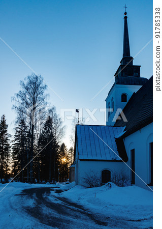 Beautiful white church of Valkeala in winter sunset, Kouvola, Finland 91785338