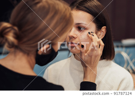 Close Up Young Woman on Beauty Procedure, Female Make Up Artist Working with the Client in the Salon 91787124