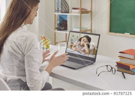 Online child education. A female teacher teaches a schoolgirl using a virtual school web chat application. Online child education. A female teacher teaches a schoolgirl using a virtual school web chat application. 91787125