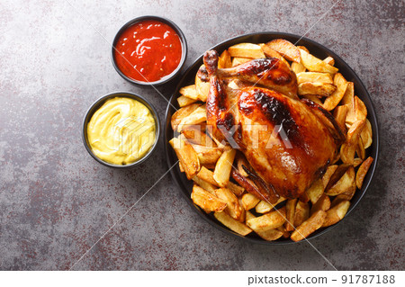 Peruvian Pollo a la Brasa chicken with fried potatoes and sauces close-up in a plate. horizontal top view Peruvian Pollo a la Brasa chicken with fried potatoes and sauces close-up in a plate. horizontal top view 91787188