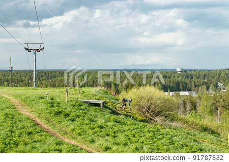 Mountain biker is jumping from the drop Mountain biker is jumping from the drop 91787882