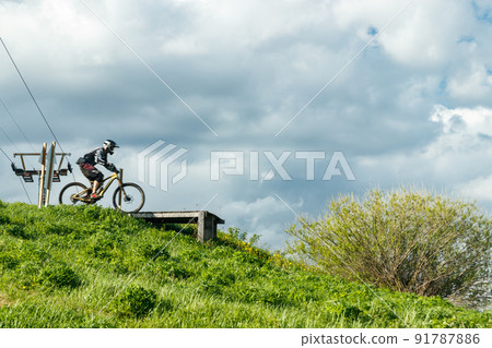 Mountain biker is jumping from the drop Mountain biker is jumping from the drop 91787886