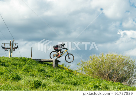 Mountain biker is jumping from the drop Mountain biker is jumping from the drop 91787889