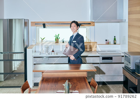 Home sales businessman standing with a leather binder Home sales businessman standing with a leather binder 91789262