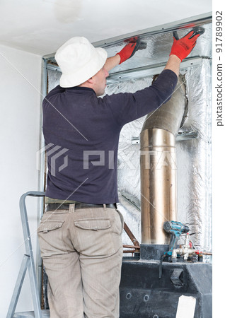 Installation of mineral wool with foil around the fireplace for thermal protection and high temperatures for the walls. Installation of mineral wool with foil around the fireplace for thermal protection and high temperatures for the walls. 91789902