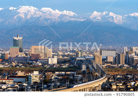 Central Toyama where the Tateyama mountain range seen from Mt. Kureha and the viaduct of the Hokuriku Shinkansen run 91790805