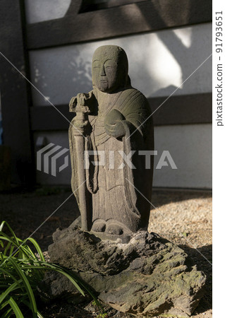 Jizo Bodhisattva statue, Bunkyo Ward, Jinkoji Temple illuminated on a winter day with a scepter in the right hand 91793651