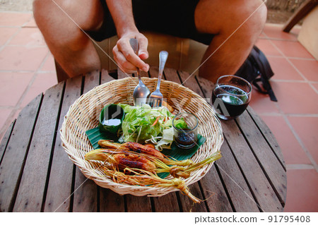 Tourist eating cambodian version of Lemongrass beef skewers or Bo Xa Nuong from Vietnam 91795408