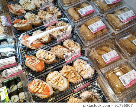 SELANGOR, MALAYSIA -MAY 2: Various types of Japanese sushi ready in packs are on display for sale. Have a price tag to make it easier for customers to buy. 91796807