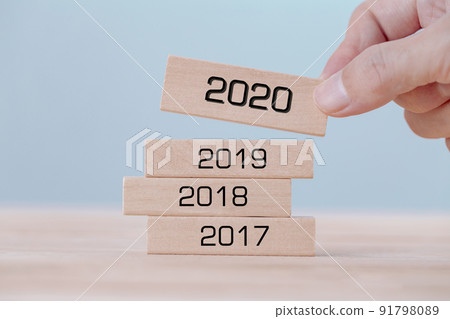 Hand holding chooses wooden block cubes with word 2020 , new year concept Hand holding chooses wooden block cubes with word 2020 , new year concept 91798089