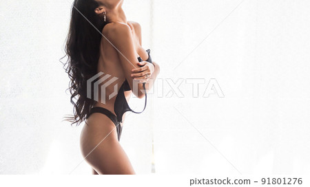 Closeup Asian woman take off black bra by white curtain Closeup Asian woman take off black bra by white curtain 91801276