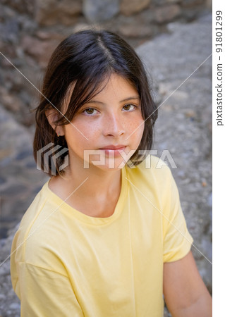 Young girl looking at the camera from below. Young girl looking at the camera from below. 91801299