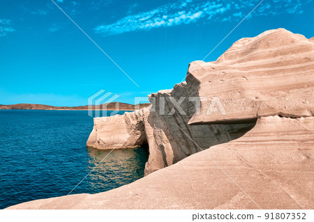 Unique rocks of Sarakiniko beach, Aegean sea, Milos island , Greece. No people, empty cliffs, summer sunshine, clear sea waters, cyan-pinkcolors 91807352