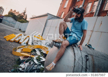 Man pilot sitting before launch quadcopter drone quad urban city Man pilot sitting before launch quadcopter drone quad urban city 91807987