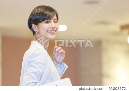 Business woman looking back at her tablet 6 91808872