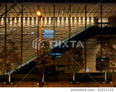 Night view of the glass wall of the building and the streetlight 91813128