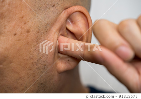 A man who plugs an ear A man who plugs an ear 91815573