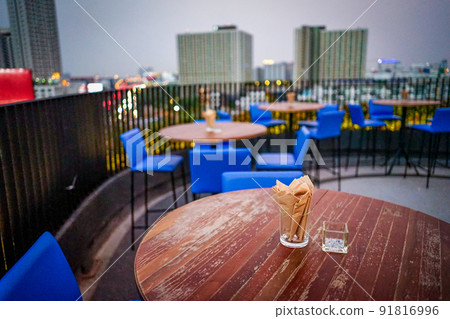 Rooftop dinner table with napkin and ashtray on it. Rooftop dinner table with napkin and ashtray on it. 91816996