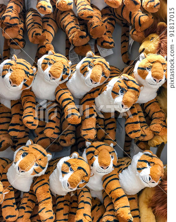 tiger dolls hang on to the wall for sales in kid depart at departmentstore. 91817015