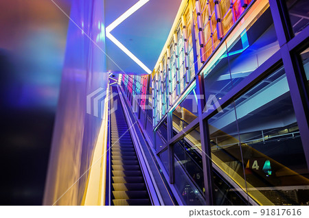 escalator with LED light beside in technology abstract neon colorful light theme. 91817616