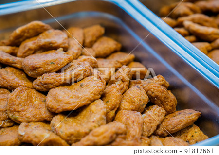 Thai fried fish paste meat balls in aluminum triangle plate on line buffet in front of seminar room. 91817661