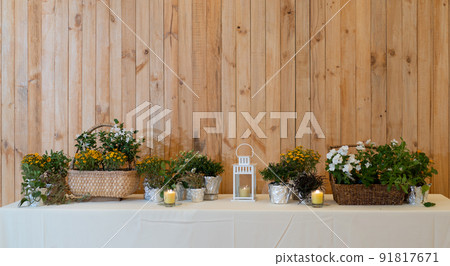 flowers decorate on the dinning long table in the luxury relax event with the wood plate background. flowers decorate on the dinning long table in the luxury relax event with the wood plate background. 91817671